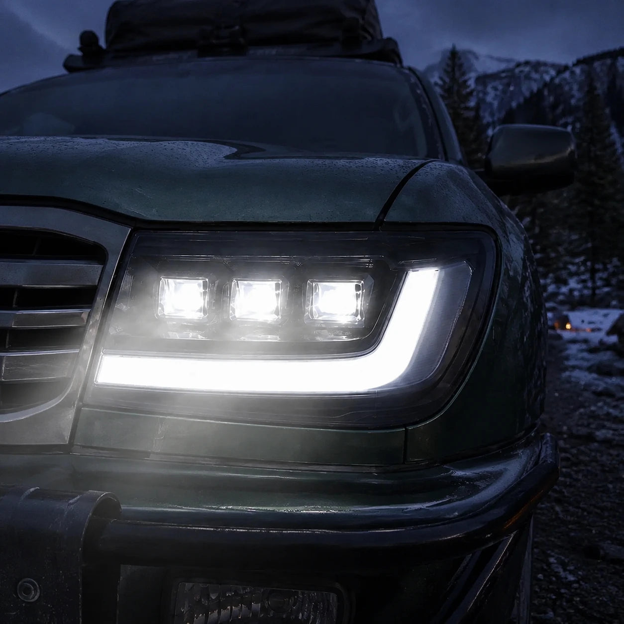 1998-2003 Toyota Land Cruiser 100 LED Triple Projector Headlights Assembly — all lights-on close-up — H-LC100-98