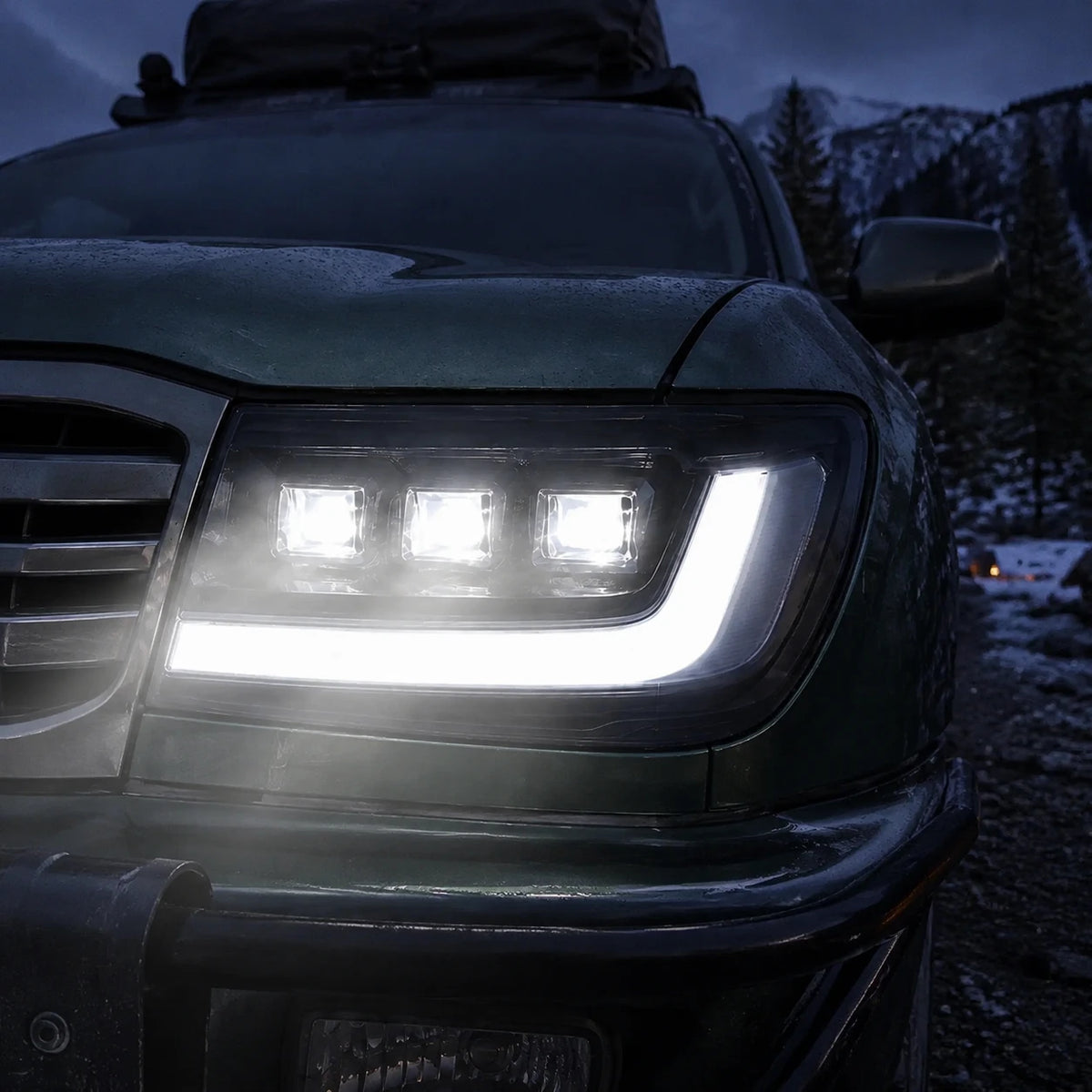 1998-2003 Toyota Land Cruiser 100 LED Triple Projector Headlights Assembly — all lights-on close-up — H-LC100-98