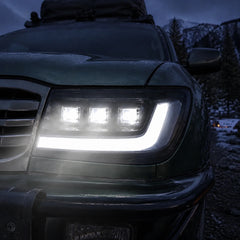 1998-2003 Toyota Land Cruiser 100 LED Triple Projector Headlights Assembly — all lights-on close-up — H-LC100-98