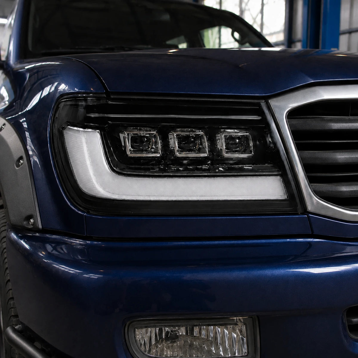 1998-2003 Toyota Land Cruiser 100 LED Triple Projector Headlights Assembly — lights-off close-up details — H-LC100-98