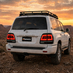 1998-2007 Toyota Land Cruiser 100 Sequential LED Tail Lights Assembly — driving in sunset — T-LC100-98-SW