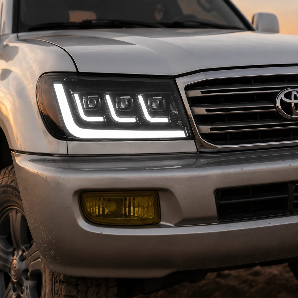 2004-2007 Toyota Land Cruiser 100 LED Triple Projector Headlights Assembly — light-on close-up — H-LC100-04