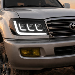2004-2007 Toyota Land Cruiser 100 LED Triple Projector Headlights Assembly — light-on close-up — H-LC100-04