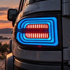 2007-2014 Toyota FJ Cruiser Sequential LED Tail Lights Assembly — Pair (Halo - Smoked RGB) — Blue RGB halo illuminated close-up — T-FJ-HL-SRGB