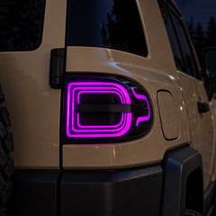 2007-2014 Toyota FJ Cruiser Sequential LED Tail Lights Assembly — Pair (Halo - Smoked RGB) — Purple halo nighttime close-up — T-FJ-HL-SRGB