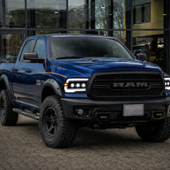 2009-2018 Ram 1500/2500/3500 and 2019-2024 Ram 1500 Classic LED Triple Projector Headlights — lights-on in urban street — H-RAM09
