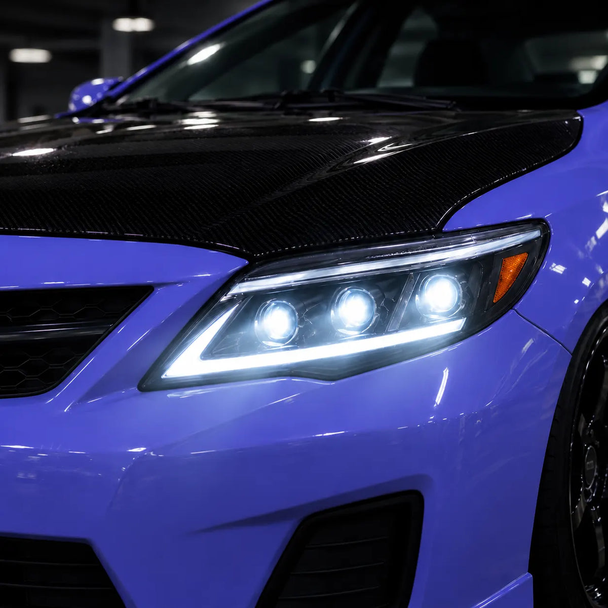 2011-2013 Toyota Corolla LED Triple Projector Headlights Assembly — Pair — illuminated headlight close-up — H-COR11-AS