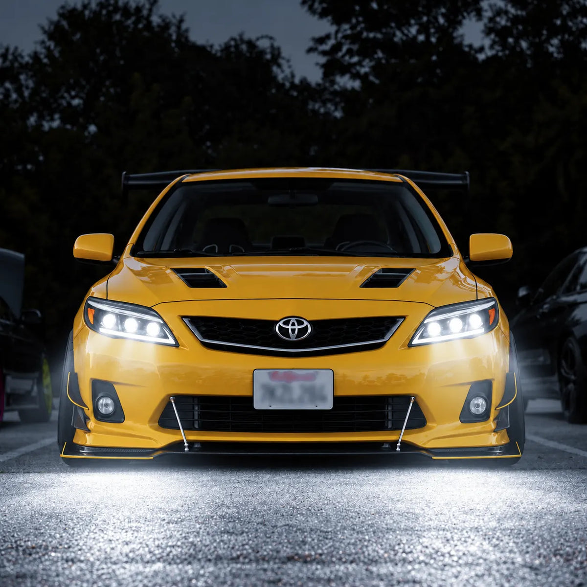 2011-2013 Toyota Corolla LED Triple Projector Headlights Assembly — Pair — beige Corolla nighttime front view — H-COR11-AS