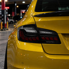 2011-2016 BMW 5 Series F10 / M5 F10 Sequential LED Tail Lights Assembly — 4-Piece Set — Smoked lens tail lights installed on yellow BMW — T-5F10-SR