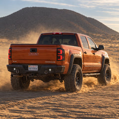 2014-2018 GMC Sierra 1500 & 2015-2019 Sierra 2500HD/3500HD LED Tail Lights Assembly — lifted truck driving off-road with illuminated tail lights — T-SIE14-SR