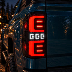 2014-2018 GMC Sierra 1500 & 2015-2019 Sierra 2500HD/3500HD LED Tail Lights Assembly — illuminated red and white LED tail light close-up at night — T-SIE14-SR