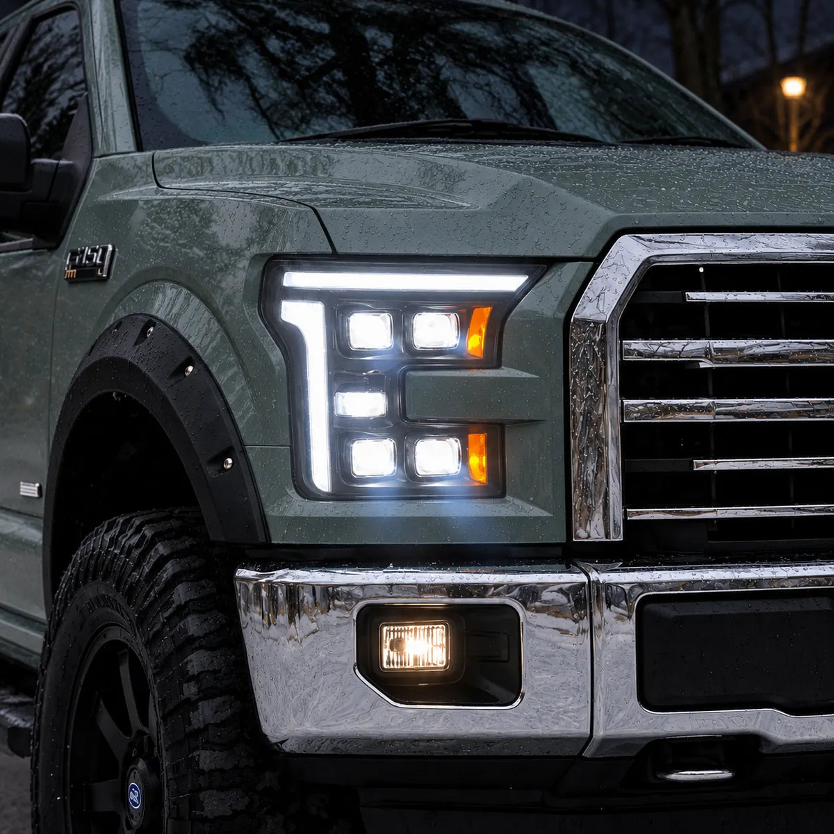 2015-2017 Ford F-150 & 2017-2020 Raptor (13th Gen) LED Projector Headlights Assembly — Pair (Quad Projector) — Illuminated headlights snowy close-up — H-F150-15-Q