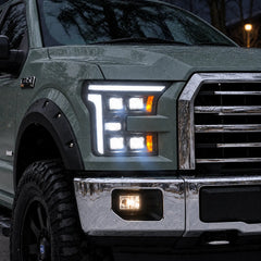 2015-2017 Ford F-150 & 2017-2020 Raptor (13th Gen) LED Projector Headlights Assembly — Pair (Quad Projector) — Illuminated headlights snowy close-up — H-F150-15-Q