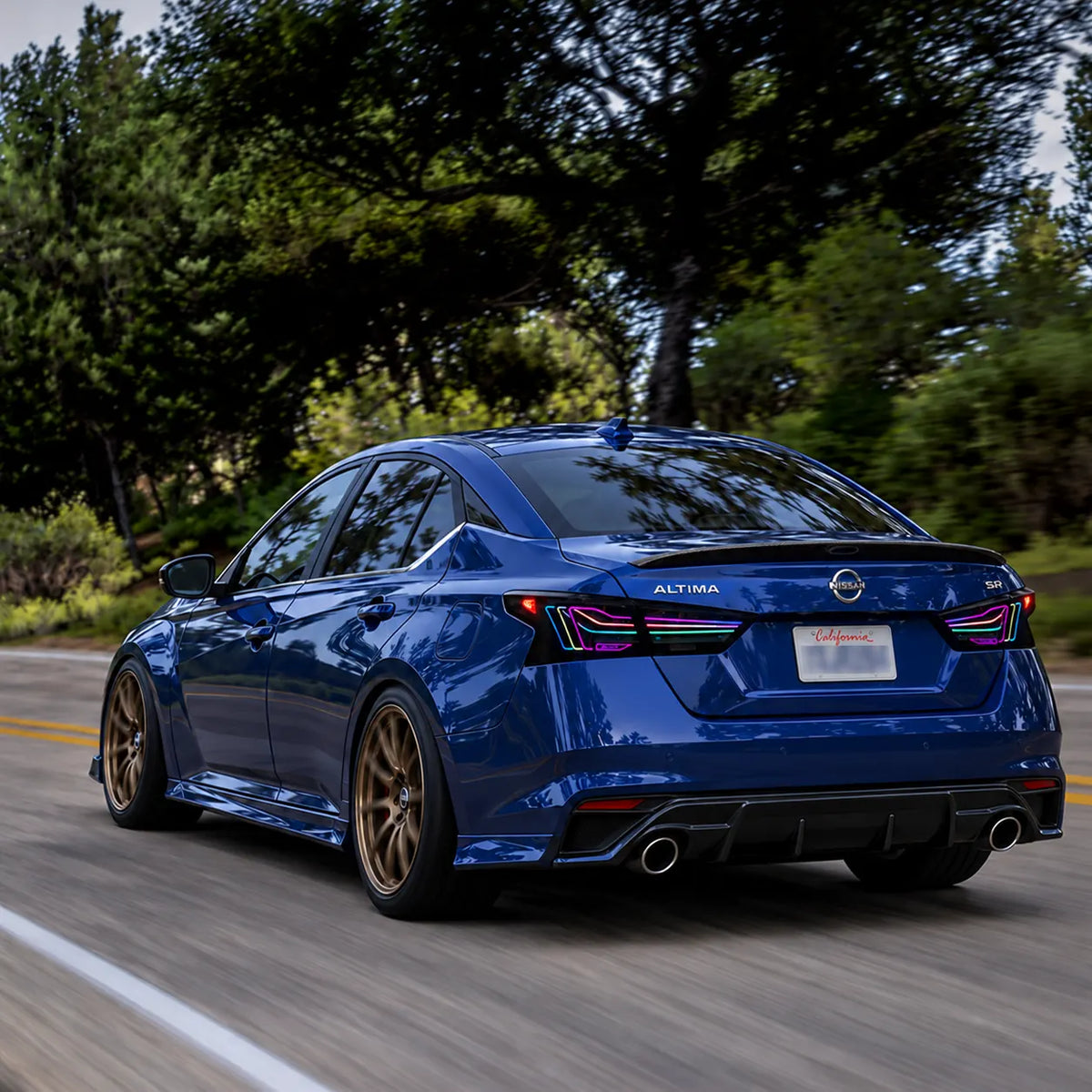 2019-2026 Nissan Altima Sequential Laser LED Tail Lights Assembly — 4-Piece Set — RGB tail lights on blue Altima driving — T-ALT19-SRGB