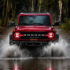 2021-2026 Ford Bronco LED Quad Projector Headlights Assembly — Pair — Red Bronco driving through water — H-BR21-4P-RGB