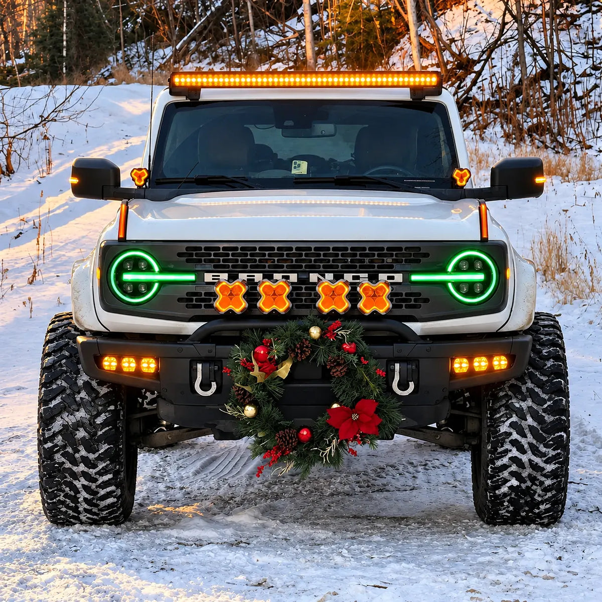 2021-2026 Ford Bronco LED Quad Projector Headlights Assembly — Pair — Green RGB headlights in snowy setting — H-BR21-4P-RGB